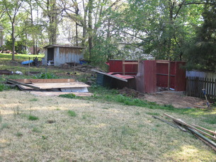 Old metal shed, with the roof removed and flipped over on the ground.
